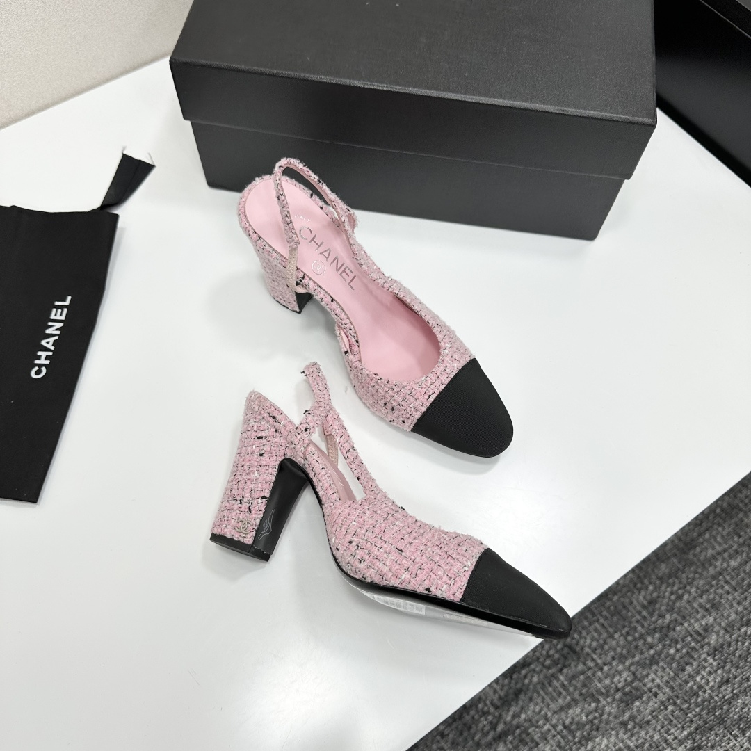 A pair of elegant Chanel pink tweed slingback pumps with black cap toes and block heels displayed on a black branded box. - Hình 10