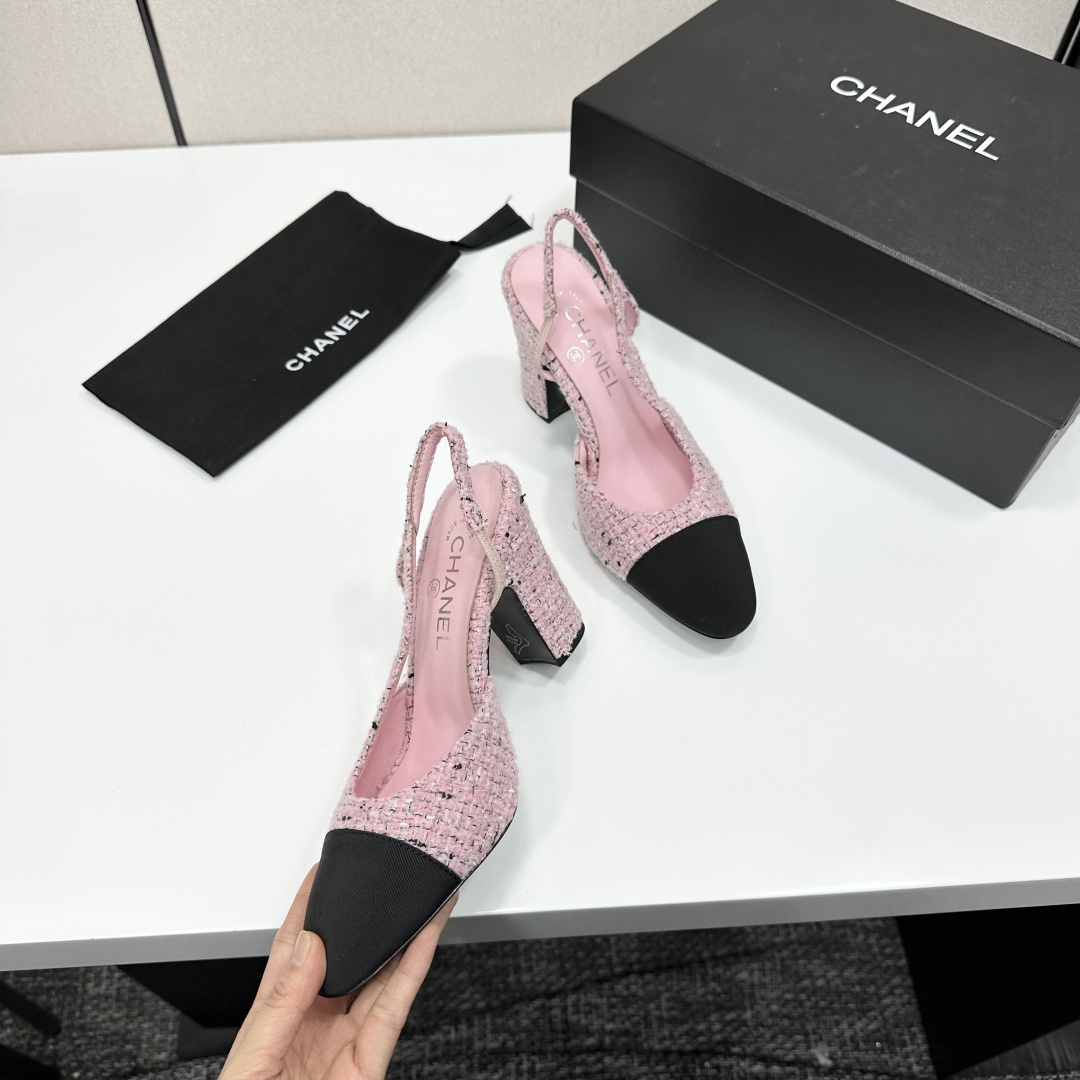 A pair of elegant Chanel pink tweed slingback pumps with black cap toes and block heels displayed on a black branded box. - Hình 9