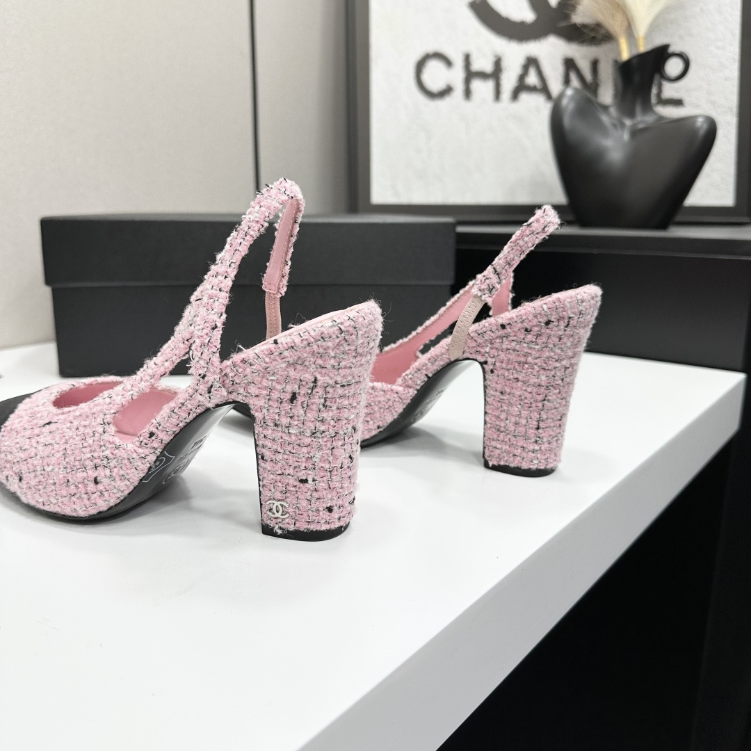 A pair of elegant Chanel pink tweed slingback pumps with black cap toes and block heels displayed on a black branded box. - Hình 8