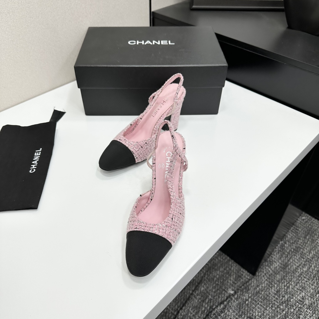 A pair of elegant Chanel pink tweed slingback pumps with black cap toes and block heels displayed on a black branded box. - Hình 6