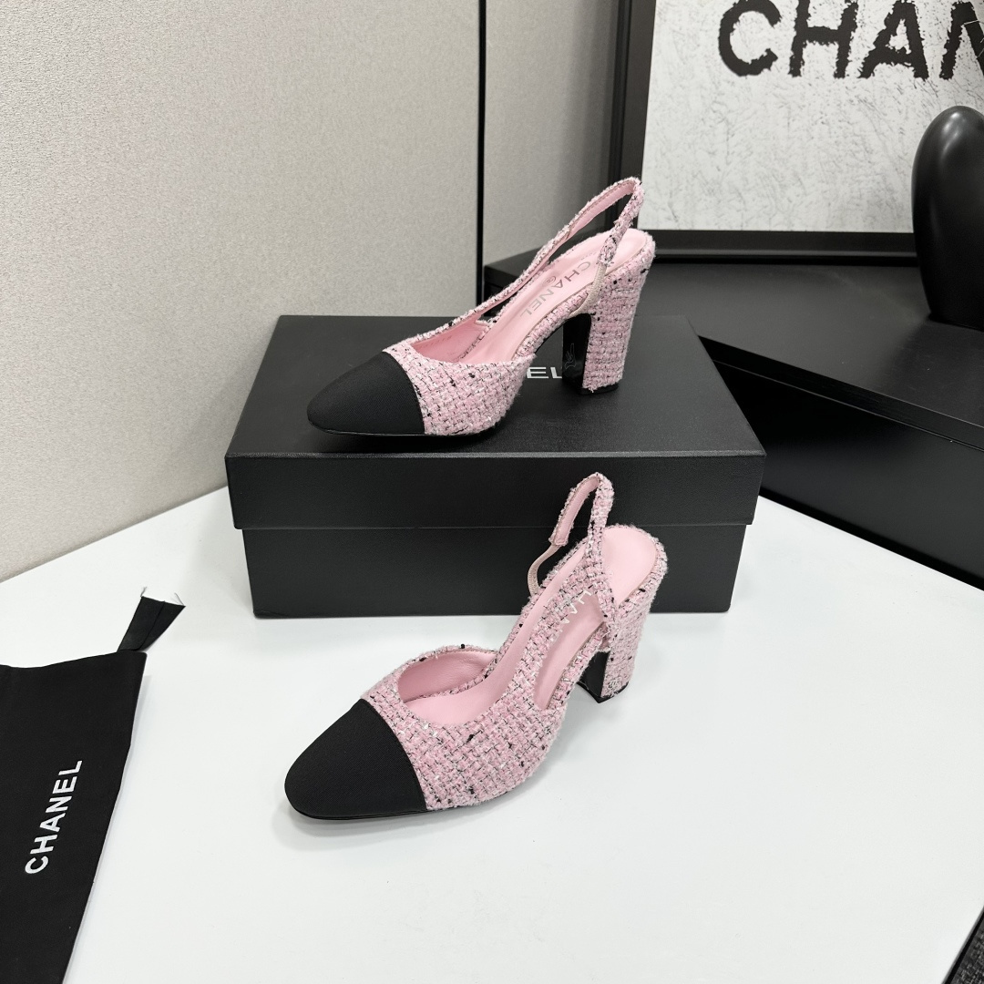 A pair of elegant Chanel pink tweed slingback pumps with black cap toes and block heels displayed on a black branded box. - Hình 3
