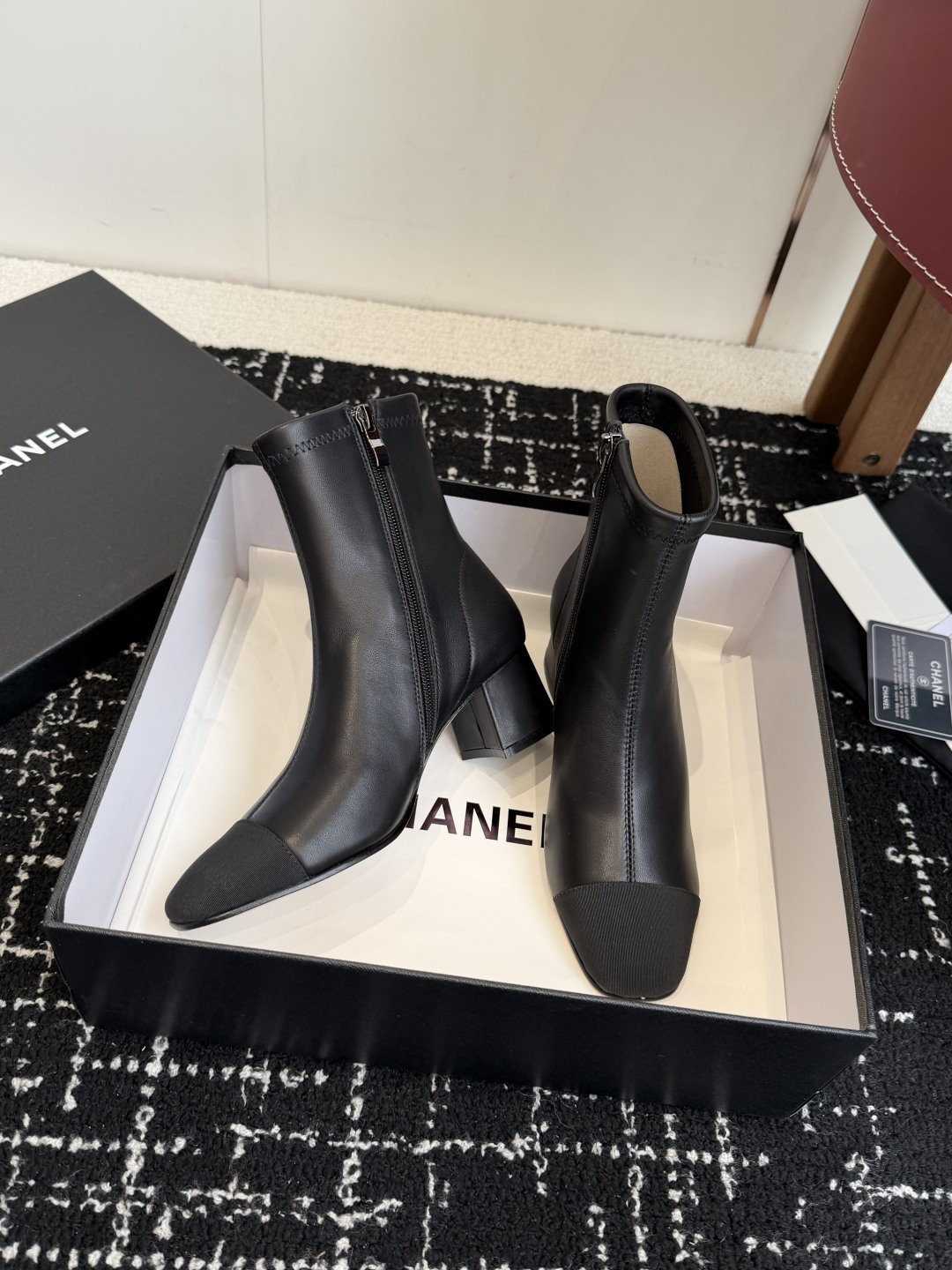 Pair of Chanel black leather ankle boots with cap toe and gold CC logo on block heel. - Hình 5