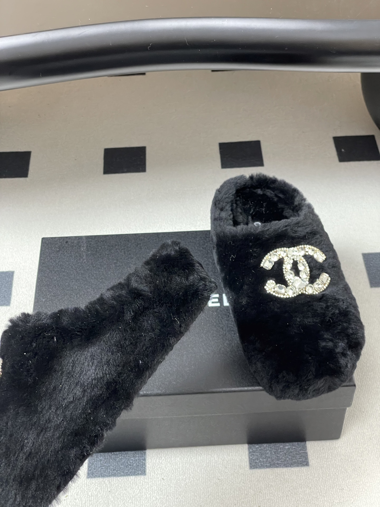 Elegant black fluffy slippers featuring a prominent crystal-studded double-C logo design on a black surface. - Hình 9