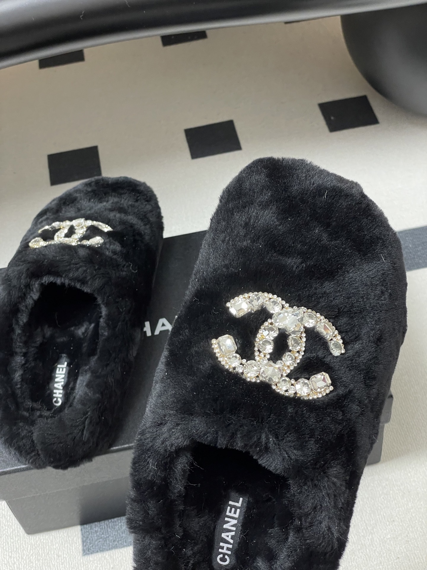 Elegant black fluffy slippers featuring a prominent crystal-studded double-C logo design on a black surface. - Hình 8