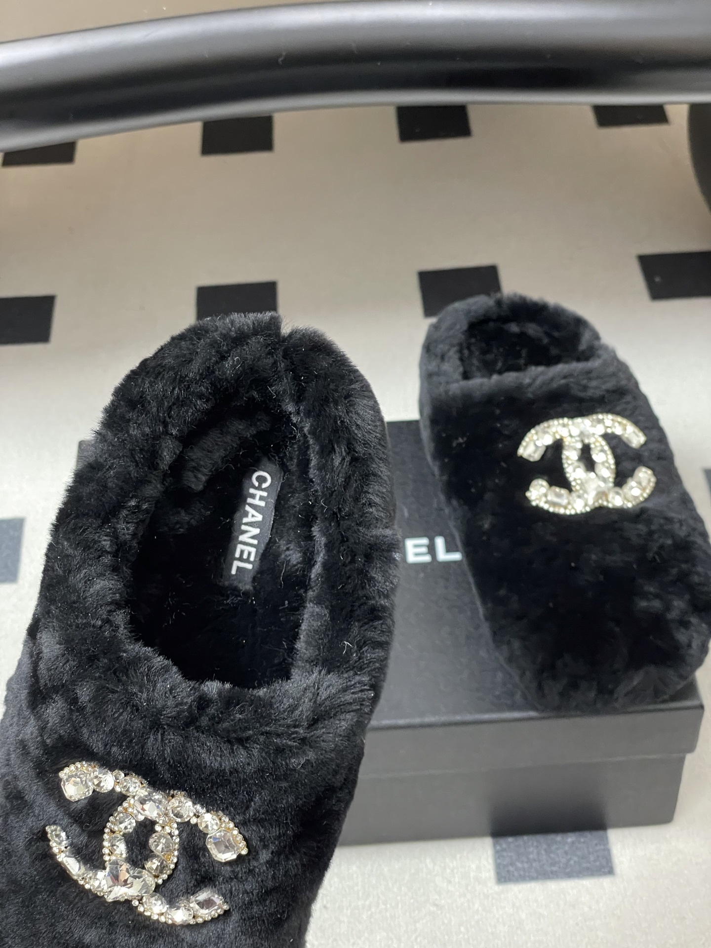 Elegant black fluffy slippers featuring a prominent crystal-studded double-C logo design on a black surface. - Hình 6