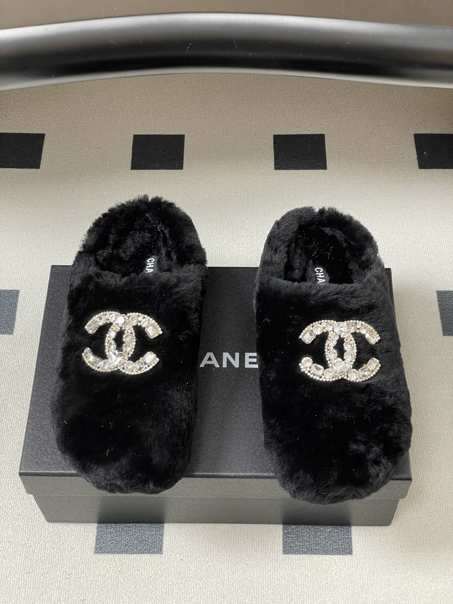 Elegant black fluffy slippers featuring a prominent crystal-studded double-C logo design on a black surface. - Hình 5