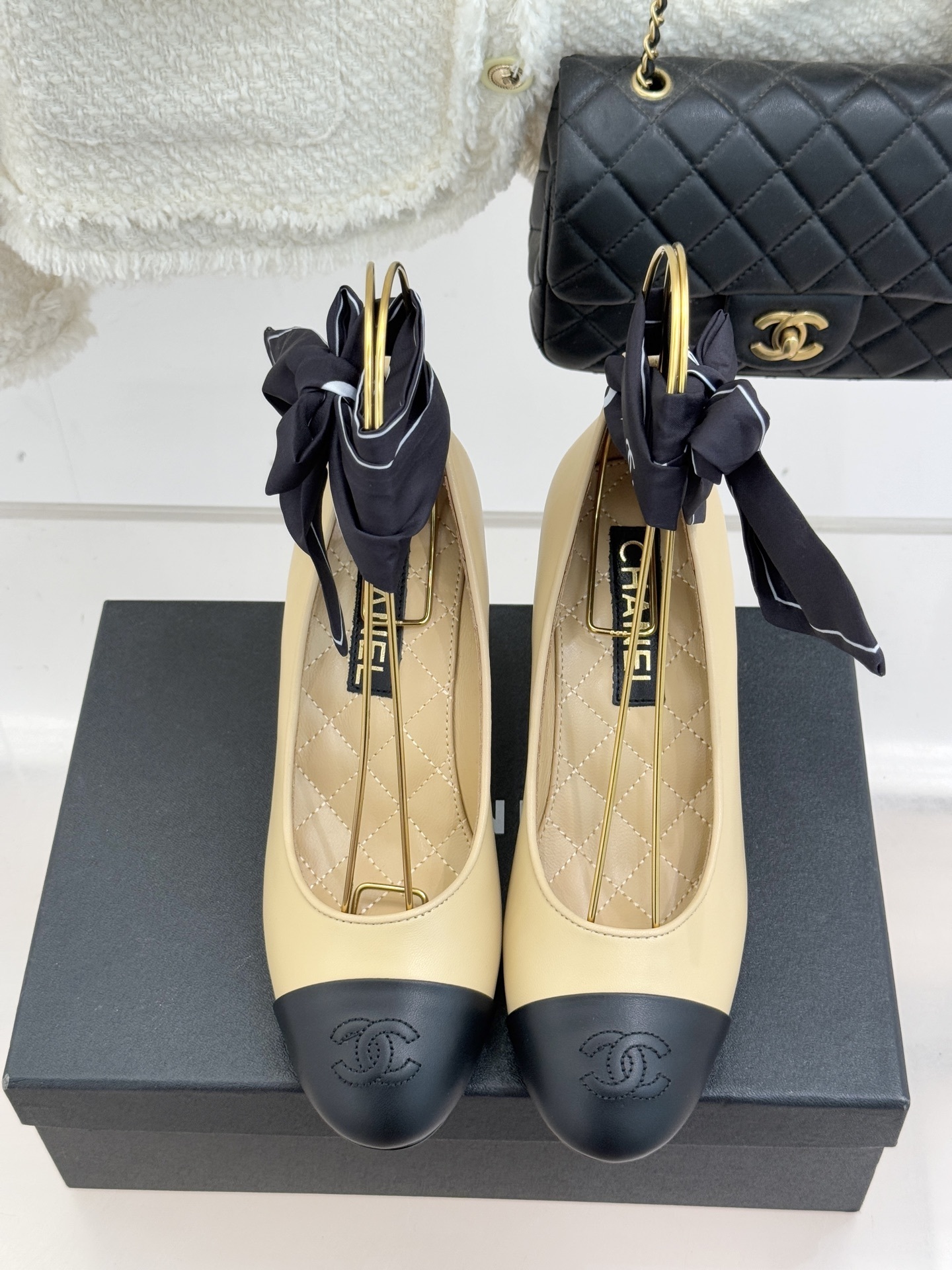 Pair of Chanel beige and black two-tone pumps with a white pearl-shaped heel and black silk ribbon bow. - Hình 4