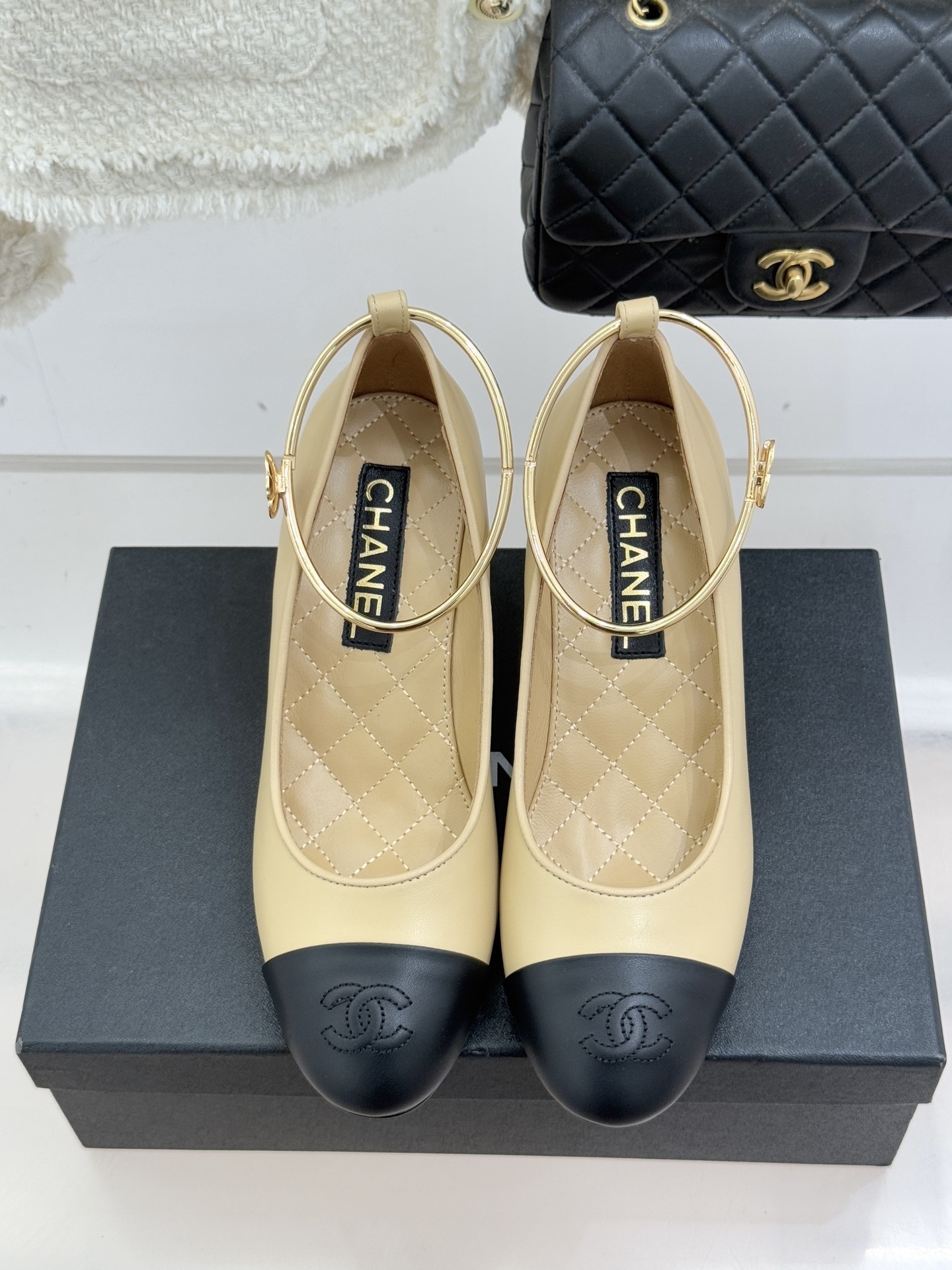 Luxury beige and black two-tone pumps with a white pearl heel and gold-tone ankle ring featuring a camellia charm. - Hình 4