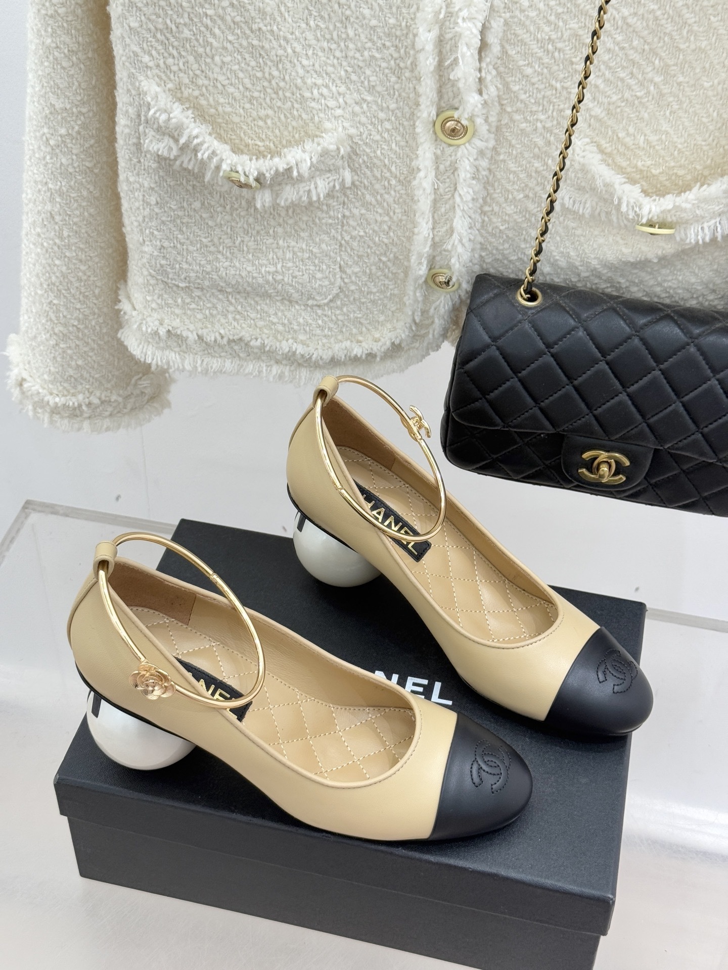 Luxury beige and black two-tone pumps with a white pearl heel and gold-tone ankle ring featuring a camellia charm. - Hình 3
