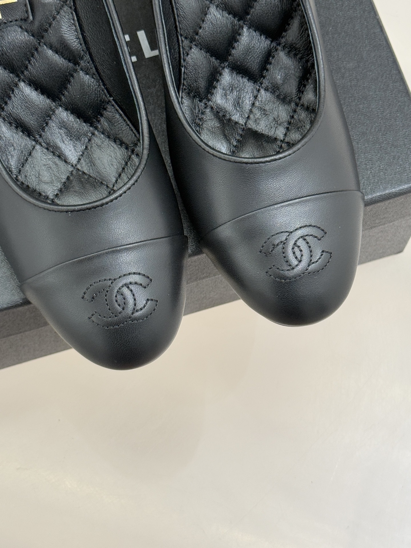 A pair of Chanel black leather pumps featuring unique white spherical pearl heels and gold-tone ankle straps with the CC logo. - Hình 7