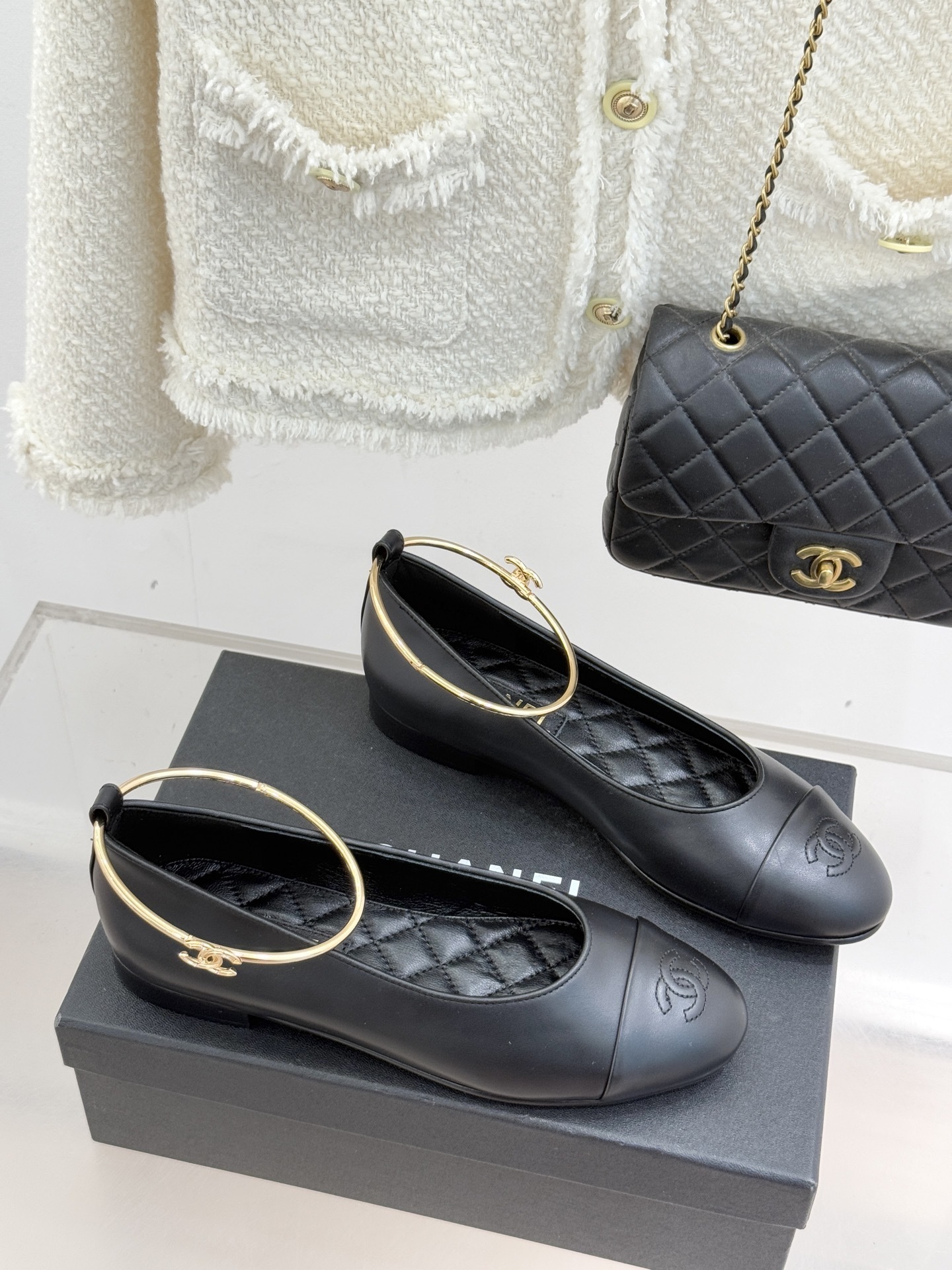 Pair of black Chanel lambskin ballet flats with gold-tone rigid ankle rings and embossed CC logos on the toe caps. - Hình 3