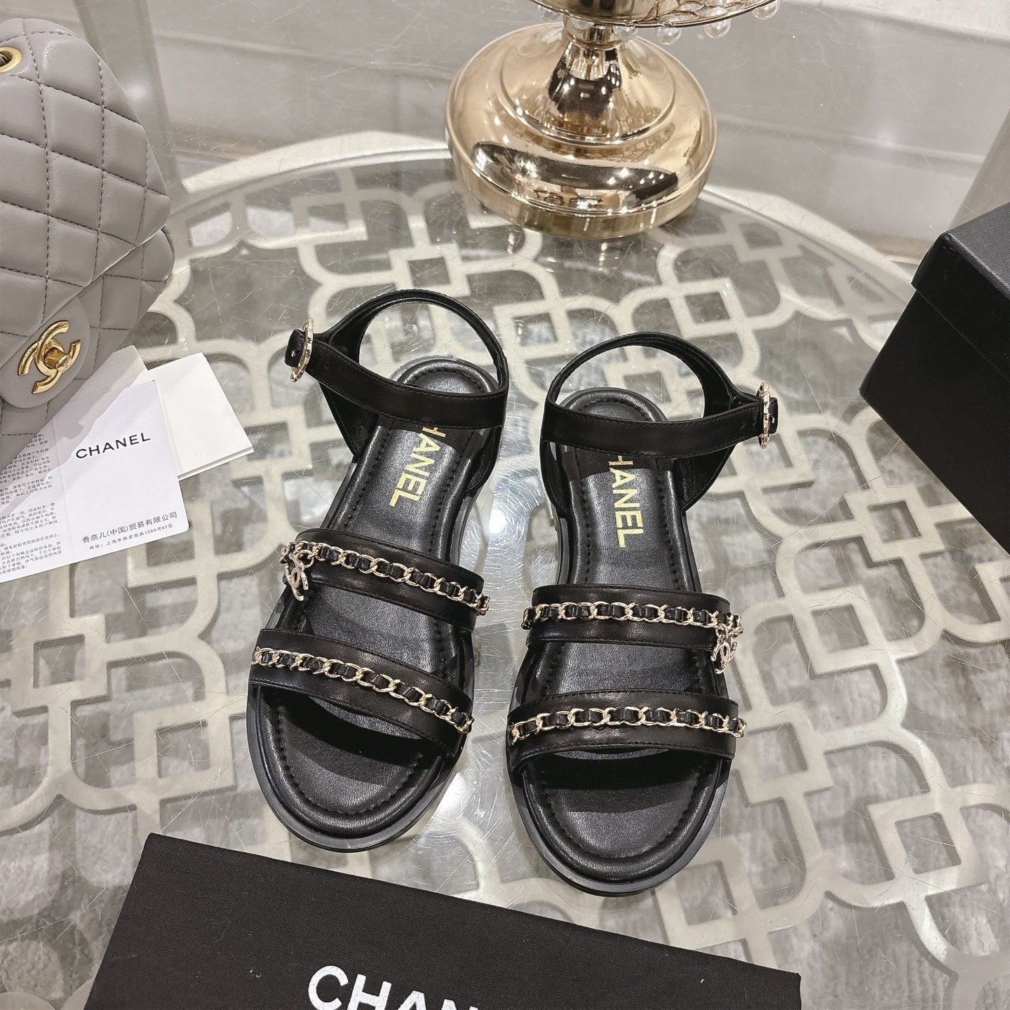 Chanel Black Leather Flat Sandals with Elegant Gold Chain Straps