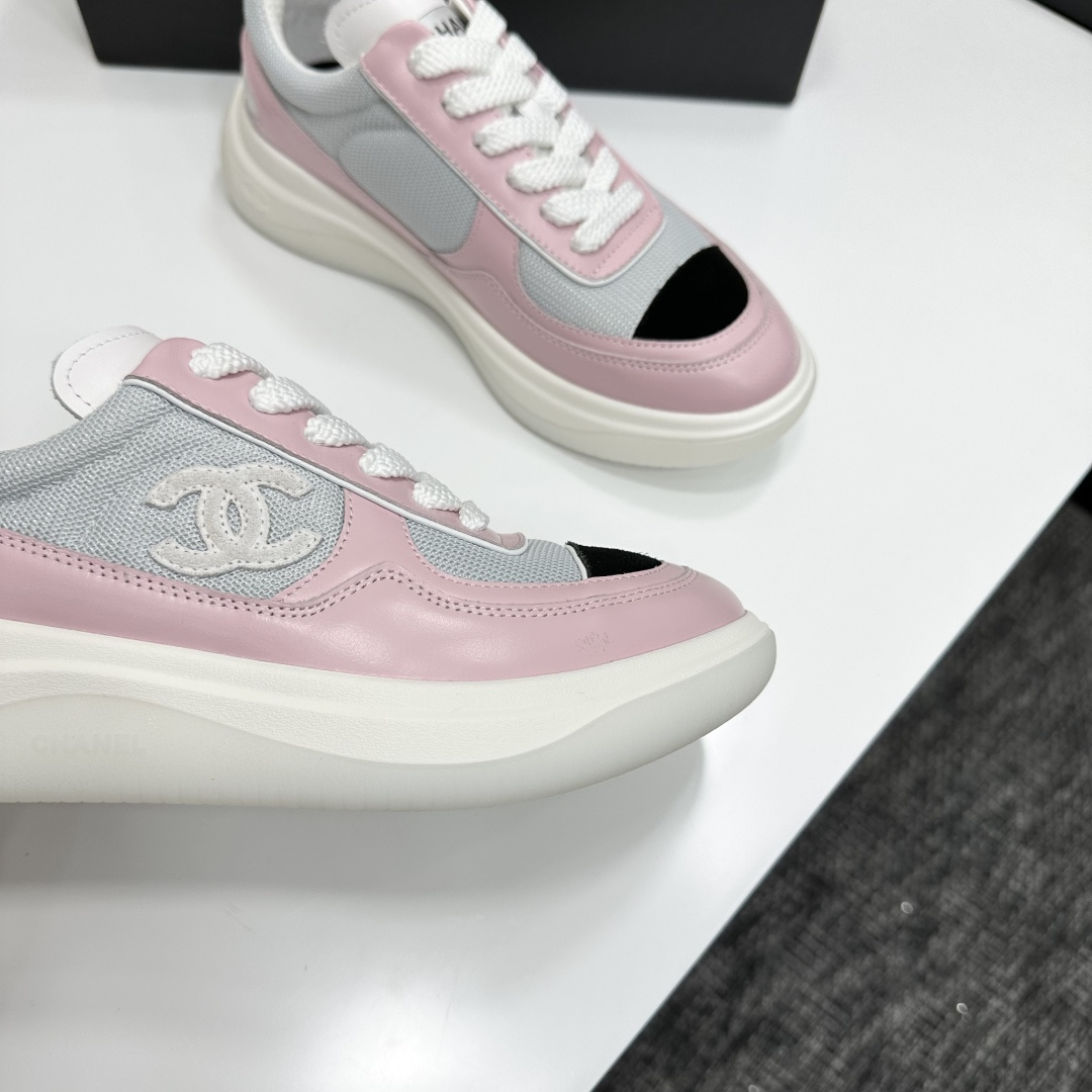 A pair of Chanel pink and grey mesh sneakers with a white platform sole and the CC logo, displayed on a black box. - Hình 10