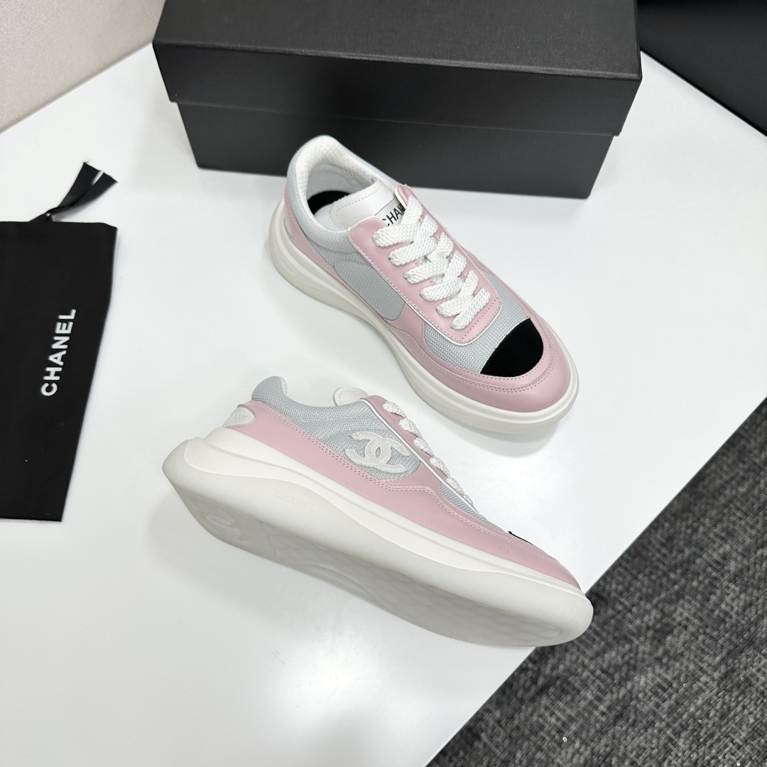 A pair of Chanel pink and grey mesh sneakers with a white platform sole and the CC logo, displayed on a black box. - Hình 9
