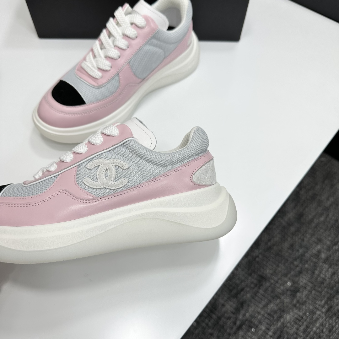 A pair of Chanel pink and grey mesh sneakers with a white platform sole and the CC logo, displayed on a black box. - Hình 7