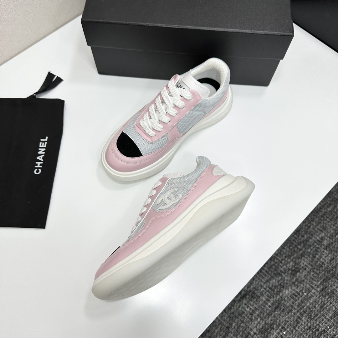 A pair of Chanel pink and grey mesh sneakers with a white platform sole and the CC logo, displayed on a black box. - Hình 6