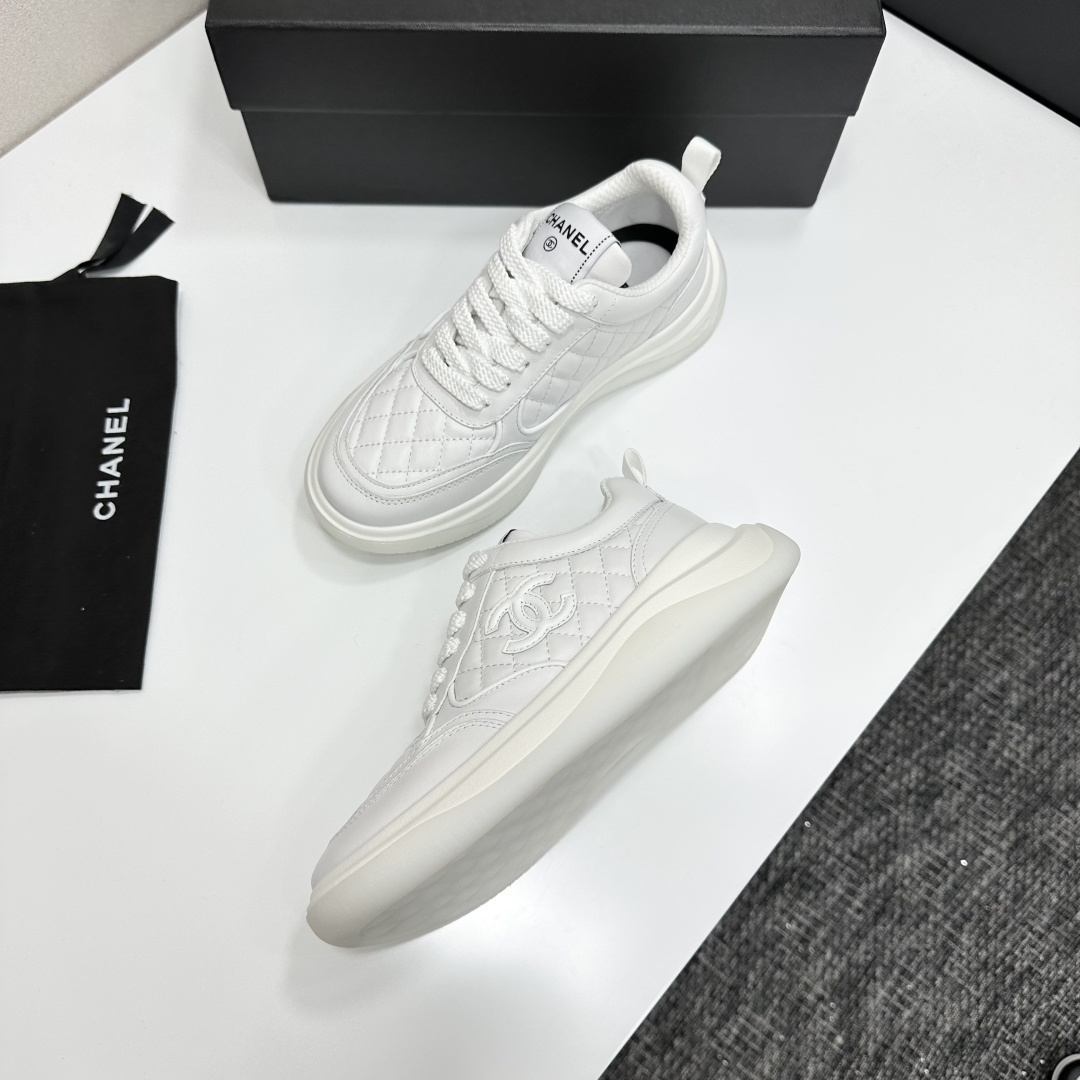 A pair of luxury white quilted leather sneakers with a thick platform sole and interlocking logo on a black display box. - Hình 6