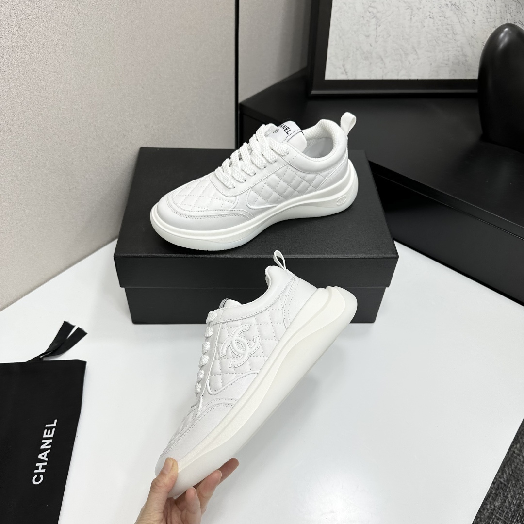 A pair of luxury white quilted leather sneakers with a thick platform sole and interlocking logo on a black display box. - Hình 4