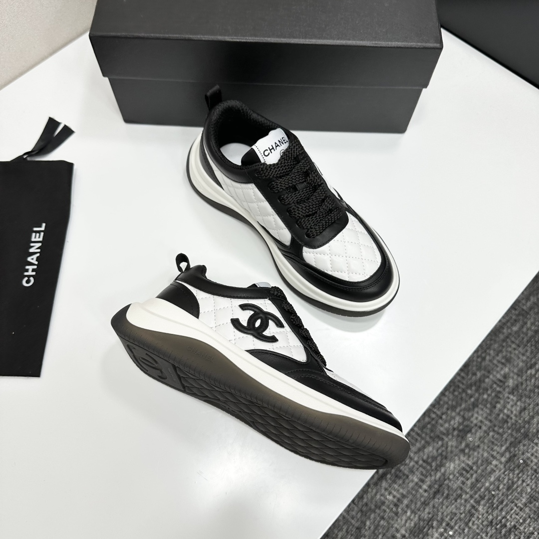 Pair of black and white Chanel quilted leather sneakers with CC logo on a black box - Hình 9