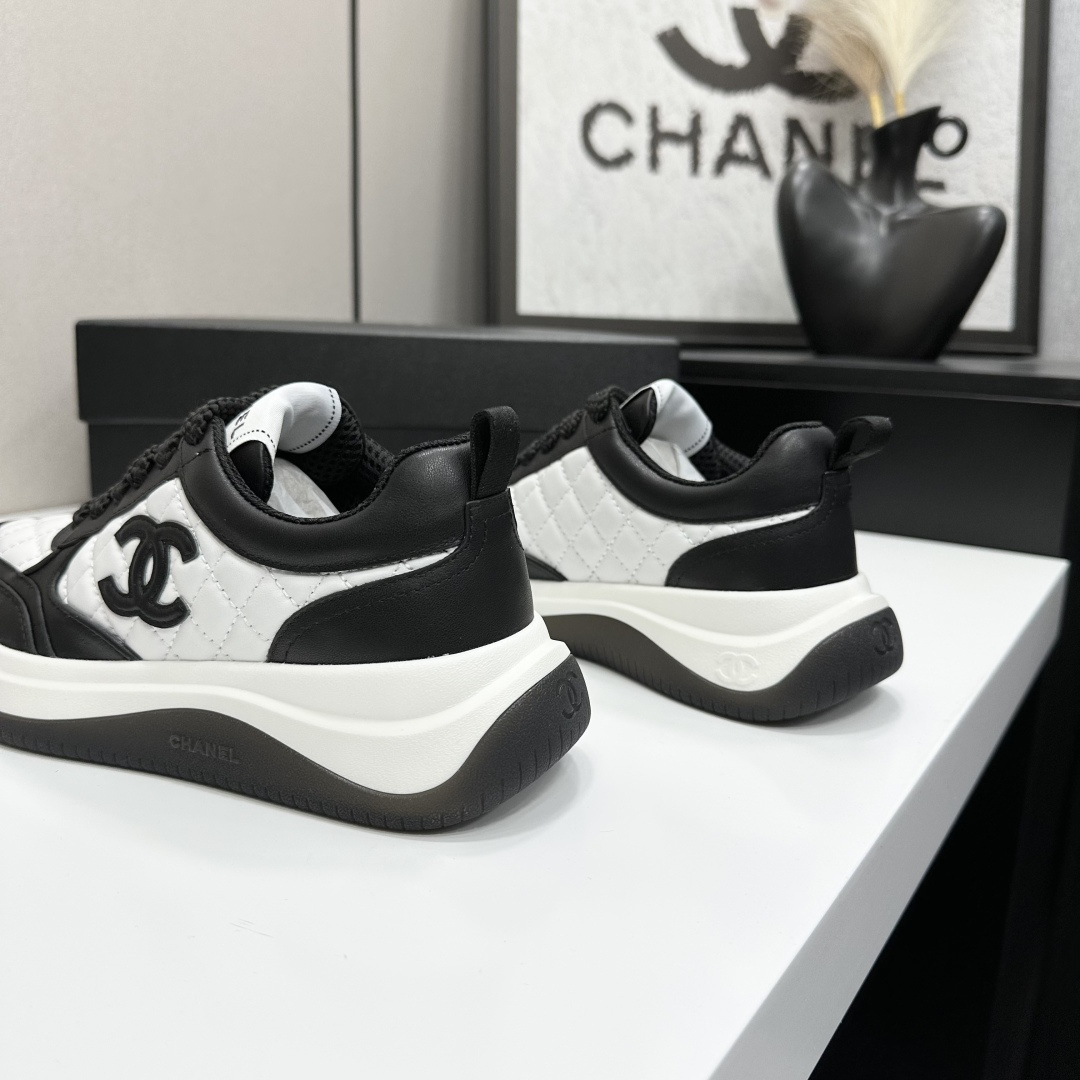 Pair of black and white Chanel quilted leather sneakers with CC logo on a black box - Hình 8
