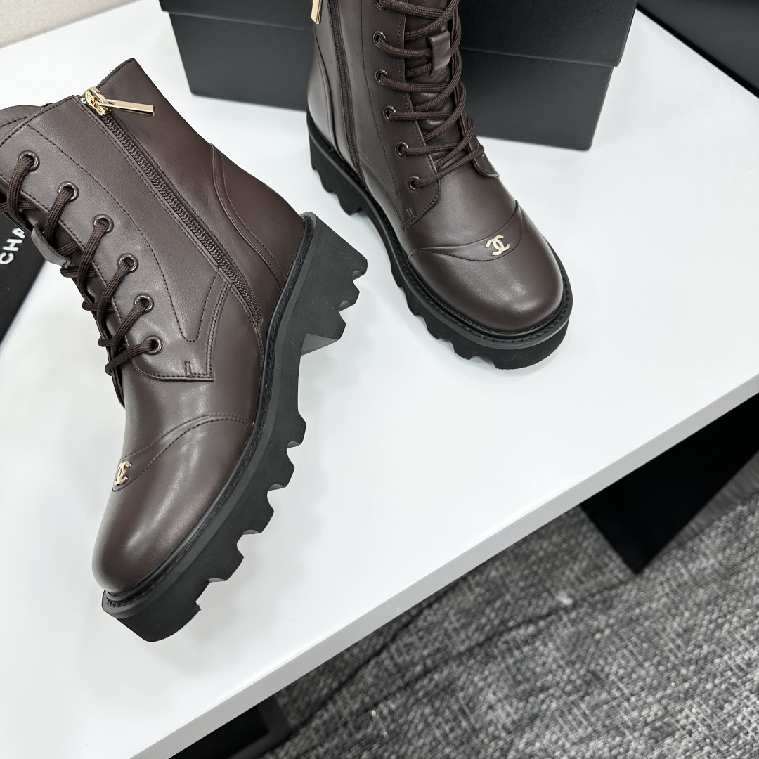 A pair of Chanel dark brown leather combat boots with chunky black lug soles and gold CC logo on the toe cap. - Hình 8