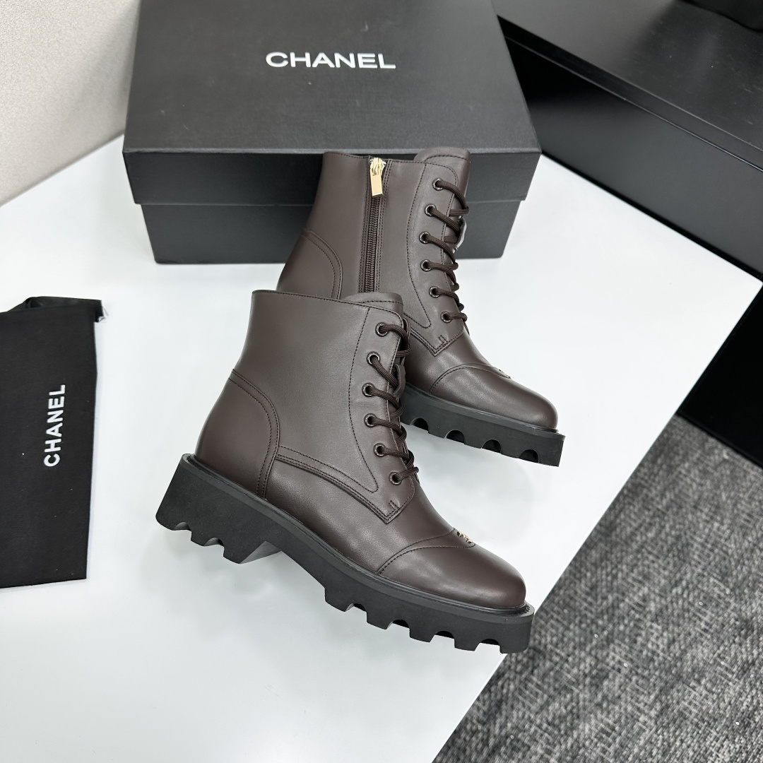 A pair of Chanel dark brown leather combat boots with chunky black lug soles and gold CC logo on the toe cap. - Hình 7