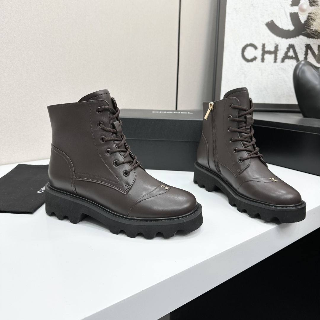 A pair of Chanel dark brown leather combat boots with chunky black lug soles and gold CC logo on the toe cap. - Hình 6