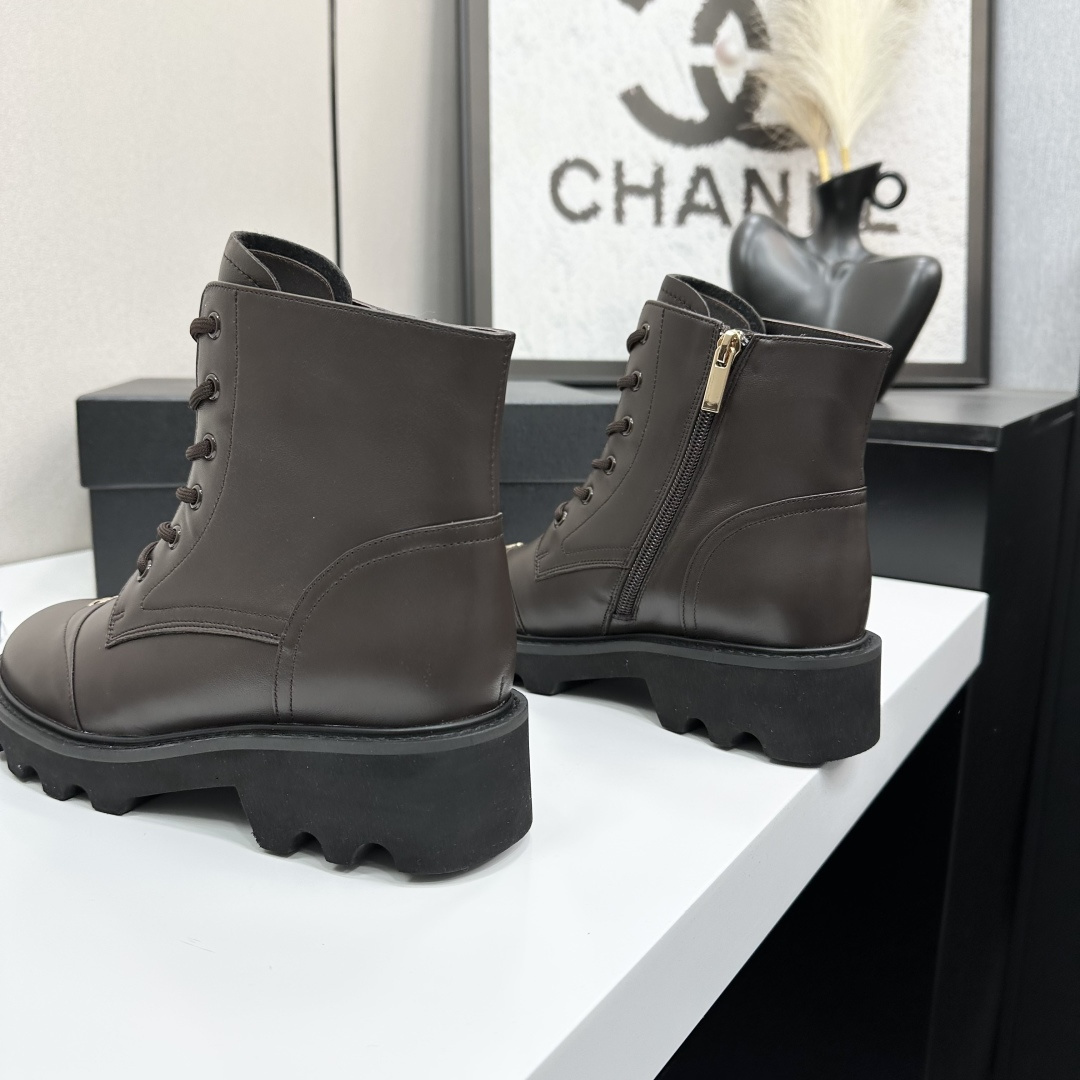 A pair of Chanel dark brown leather combat boots with chunky black lug soles and gold CC logo on the toe cap. - Hình 5