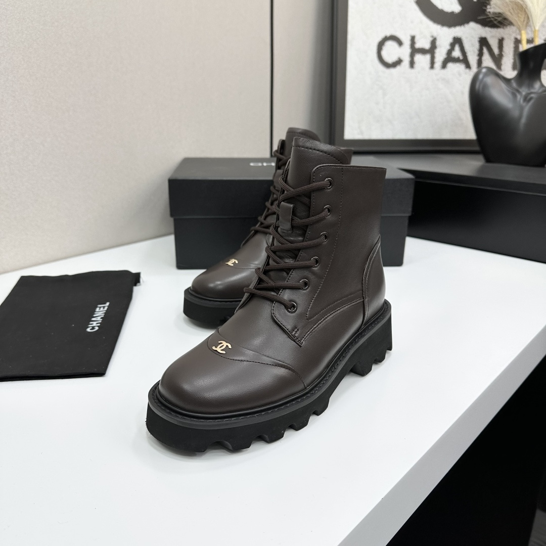 A pair of Chanel dark brown leather combat boots with chunky black lug soles and gold CC logo on the toe cap. - Hình 4