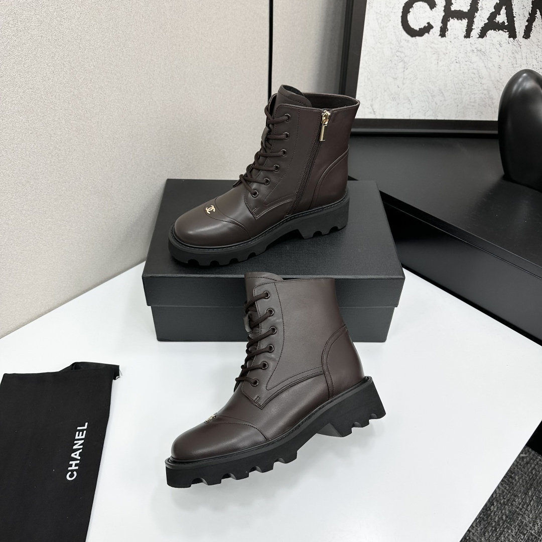 A pair of Chanel dark brown leather combat boots with chunky black lug soles and gold CC logo on the toe cap. - Hình 3