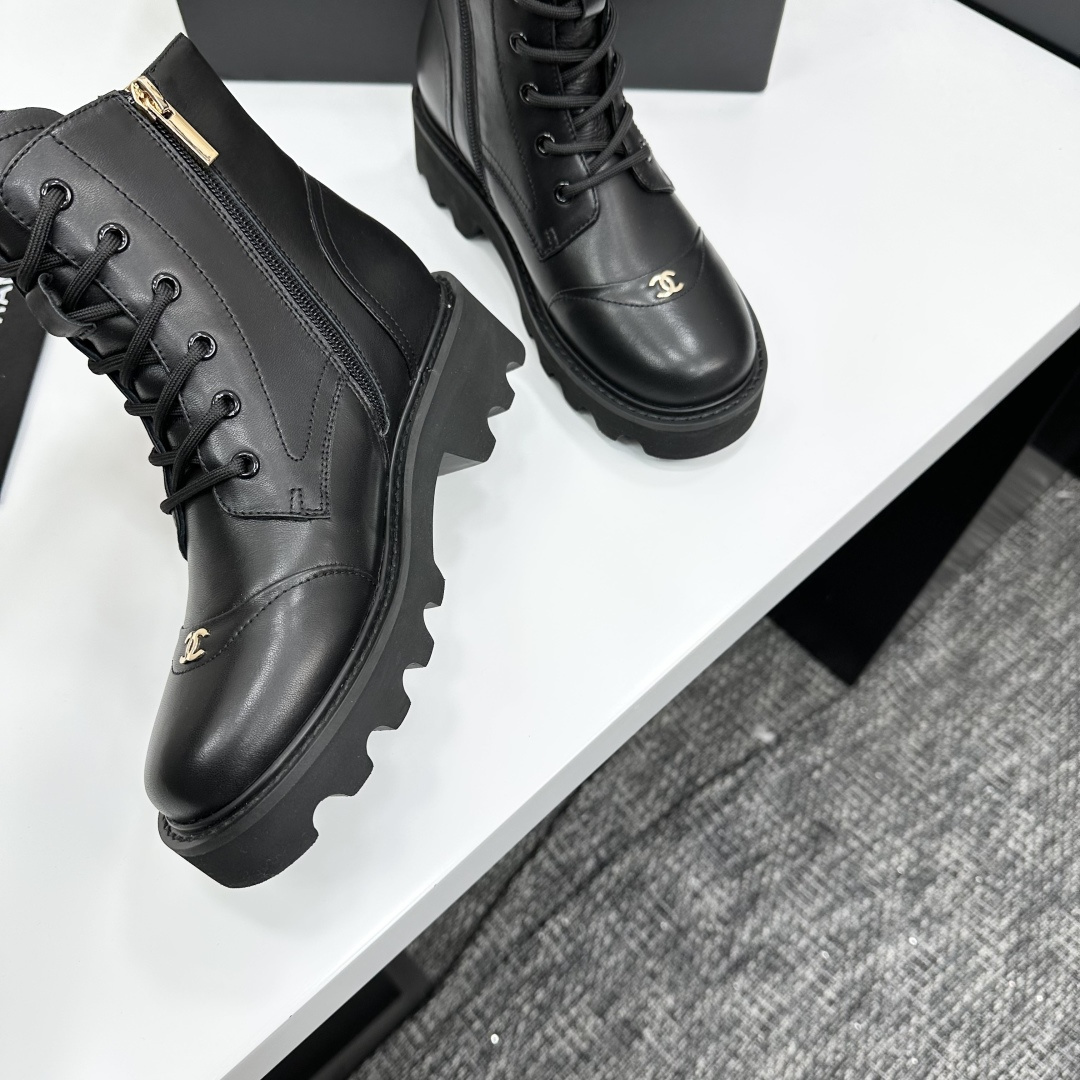 High-end black leather combat boots with lace-up front, side zipper, and chunky lug sole displayed on a black box. - Hình 9