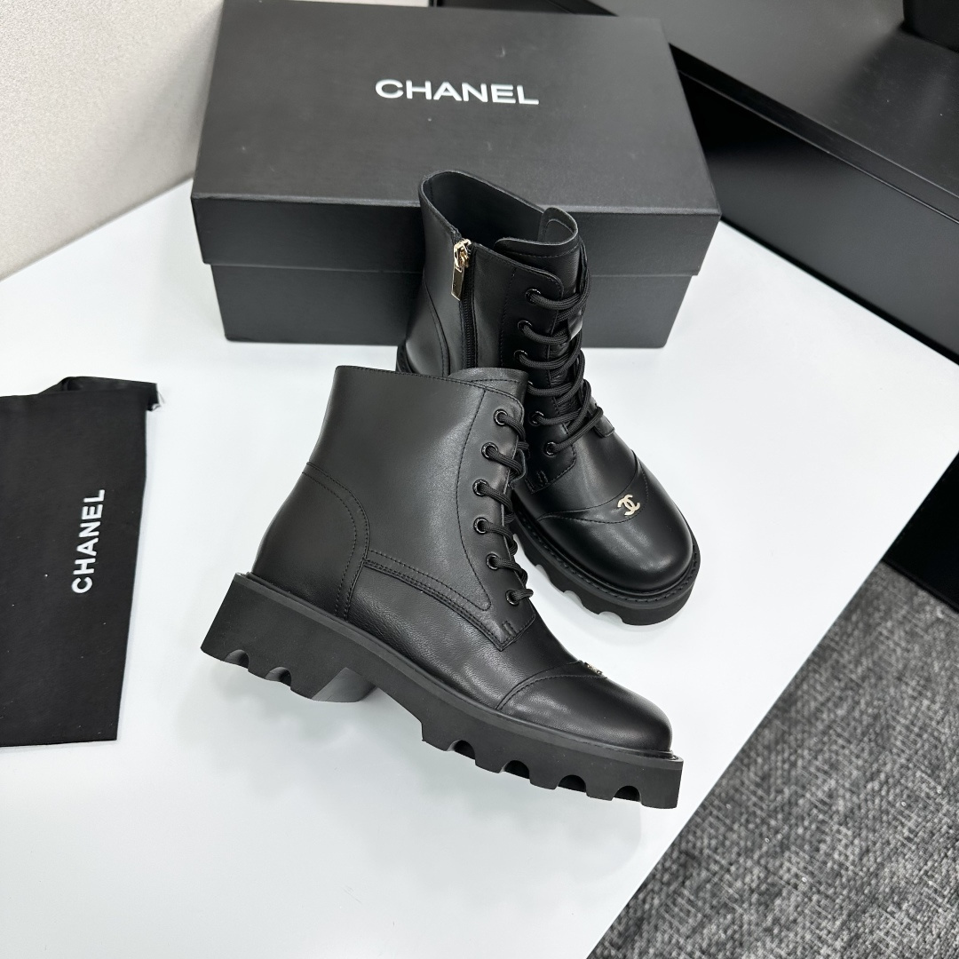 High-end black leather combat boots with lace-up front, side zipper, and chunky lug sole displayed on a black box. - Hình 7