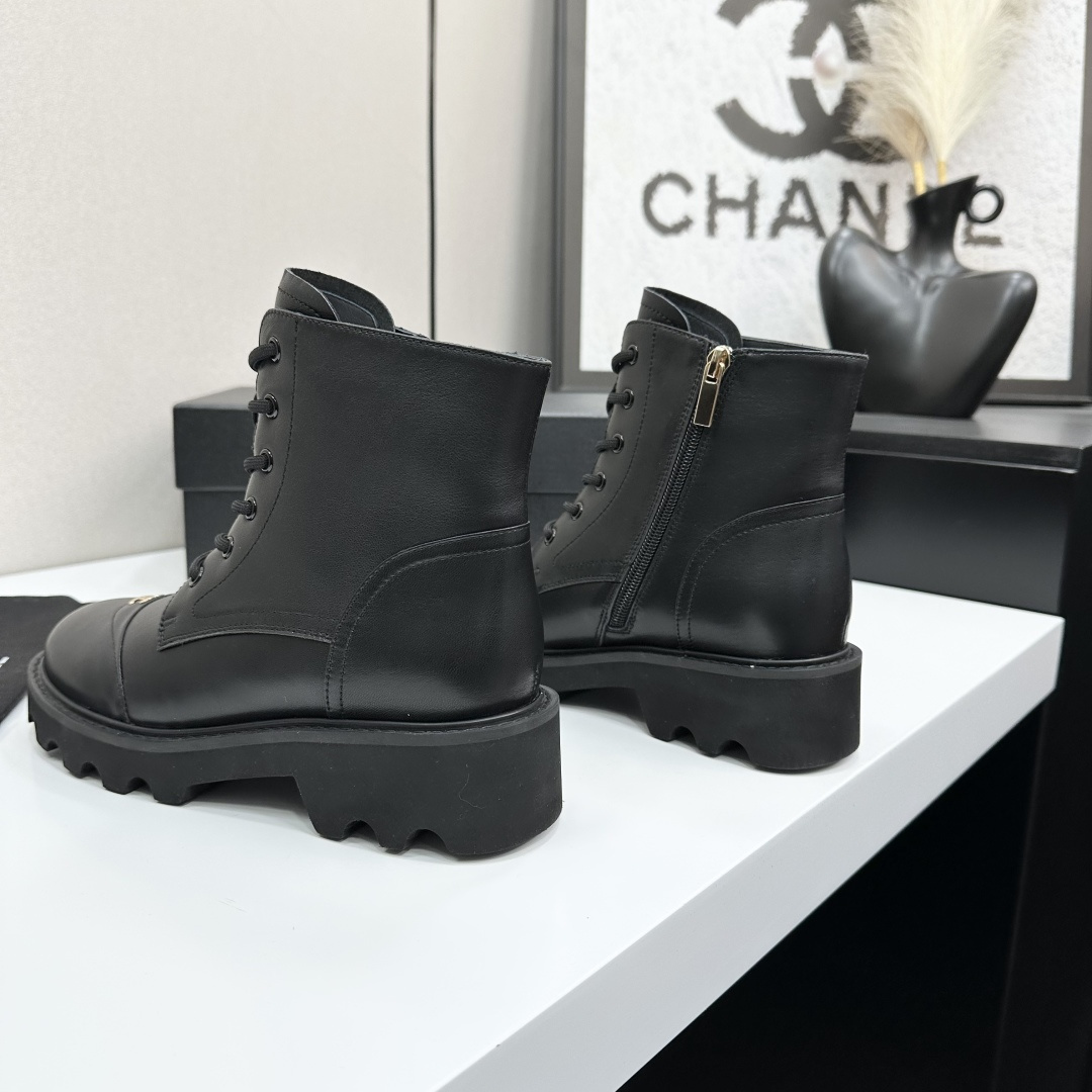 High-end black leather combat boots with lace-up front, side zipper, and chunky lug sole displayed on a black box. - Hình 5