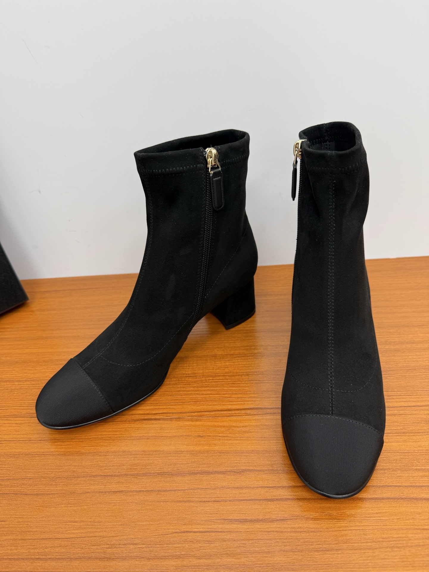A pair of Chanel black suede ankle boots with ribbed cap toes and gold-tone CC logo on the block heels. - Hình 7