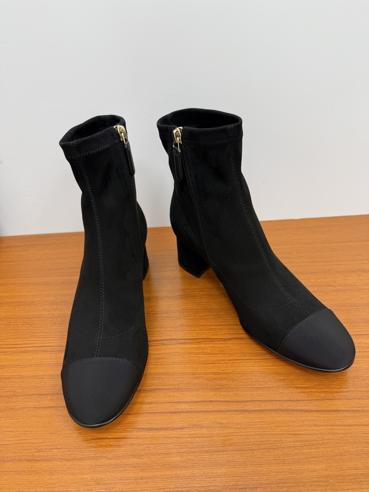 A pair of Chanel black suede ankle boots with ribbed cap toes and gold-tone CC logo on the block heels. - Hình 6