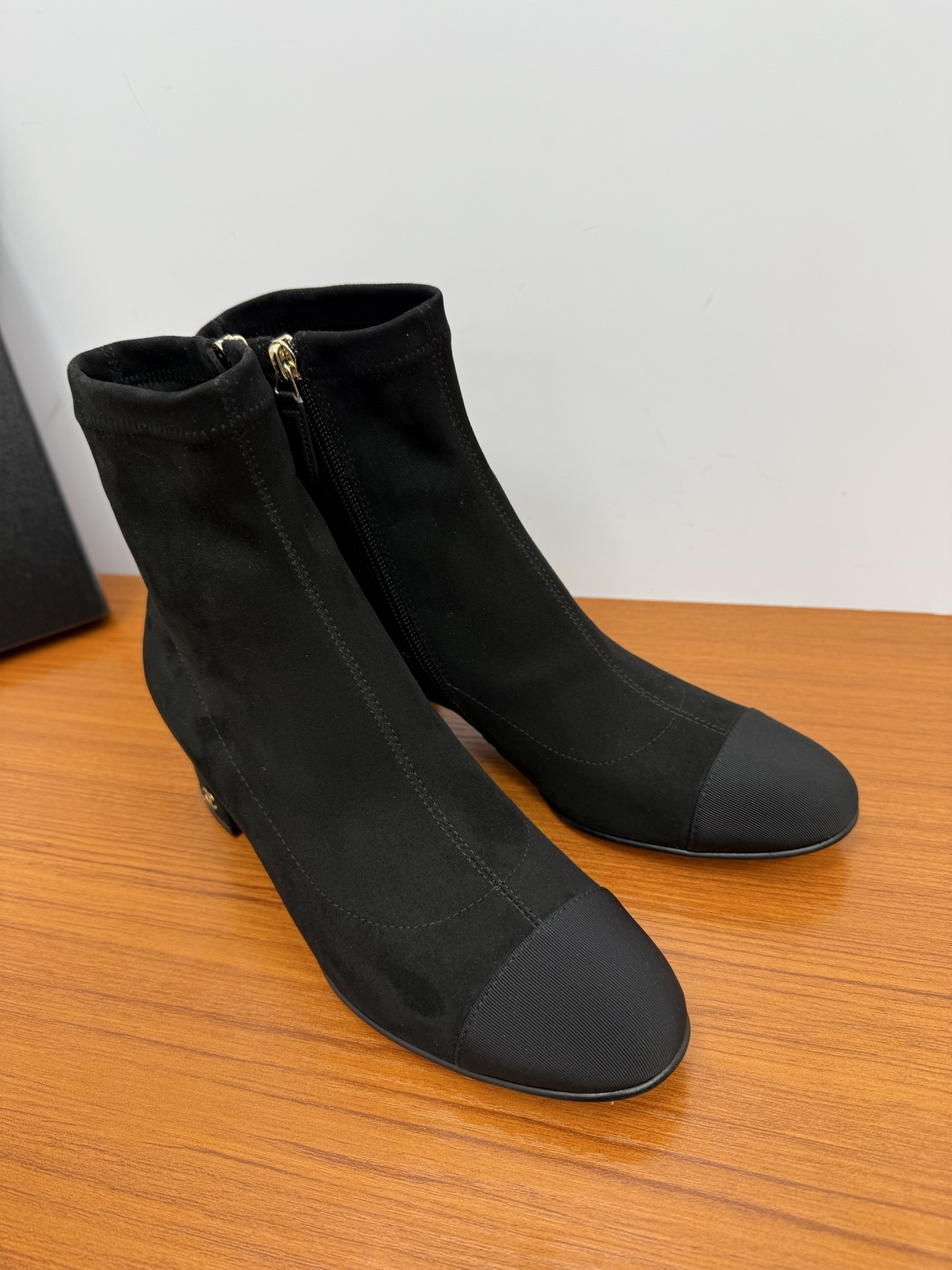 A pair of Chanel black suede ankle boots with ribbed cap toes and gold-tone CC logo on the block heels. - Hình 2
