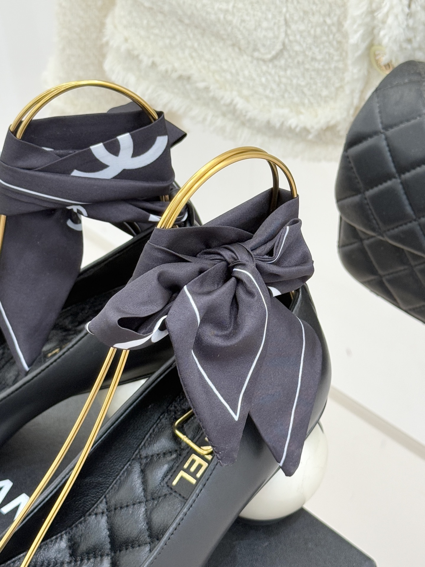 Pair of black Chanel leather pumps with white pearl spherical heels and black silk ribbons tied at the ankles. - Hình 8