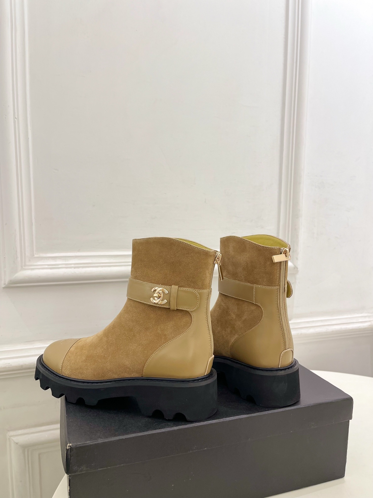 Luxury Chanel tan suede ankle boots with chunky black soles and gold CC buckle detail on a designer box. - Hình 8