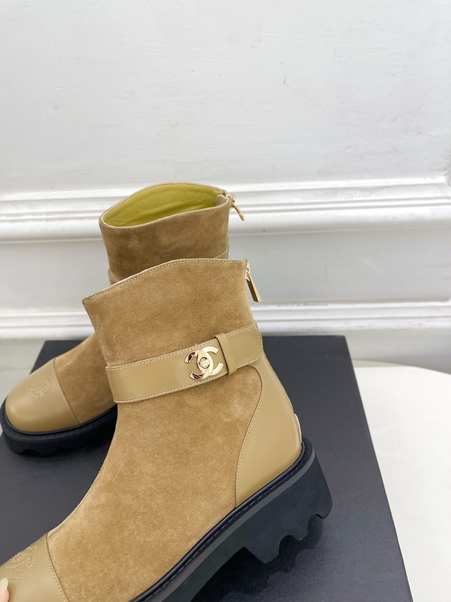 Luxury Chanel tan suede ankle boots with chunky black soles and gold CC buckle detail on a designer box. - Hình 7