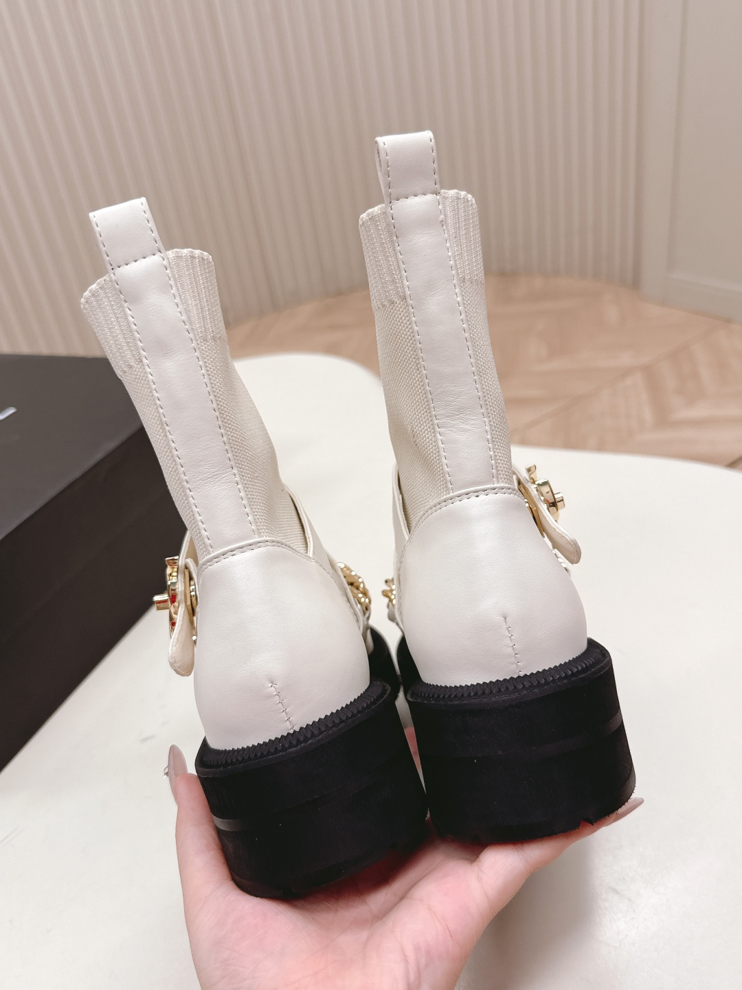 Pair of Chanel white leather sock ankle boots with gold chain and CC logo on a white table - Hình 8