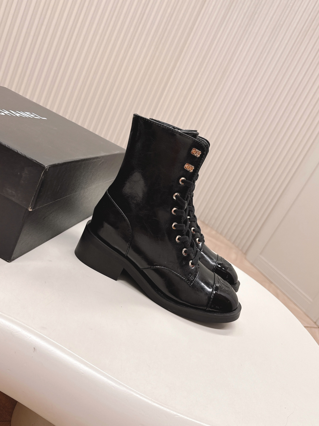 Pair of Chanel black patent leather lace-up ankle boots with embossed CC logo on toe cap and gold-tone hardware. - Hình 3