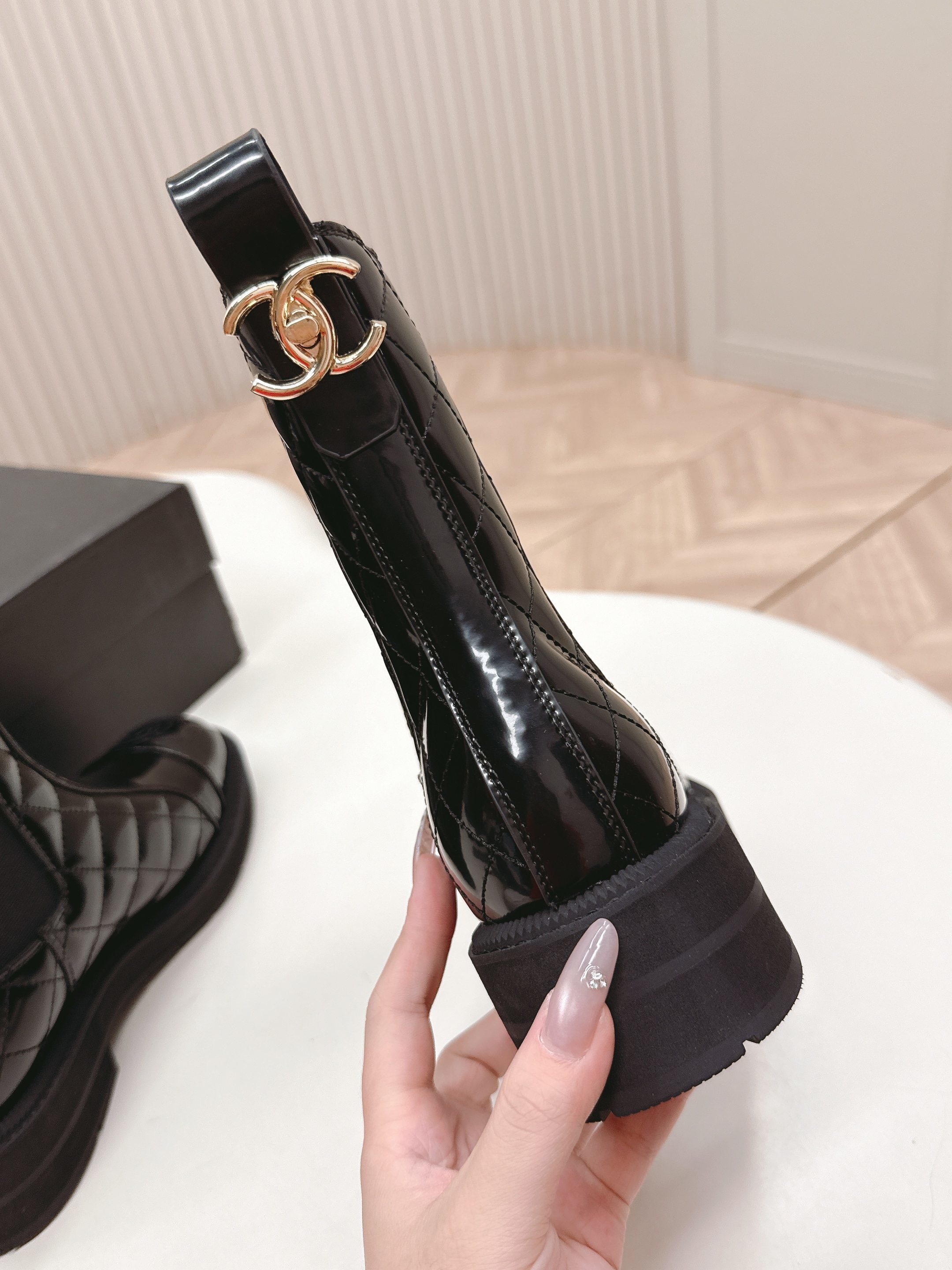 Pair of black Chanel quilted patent leather Chelsea boots with platform soles and embossed CC logo on the toe cap. - Hình 6