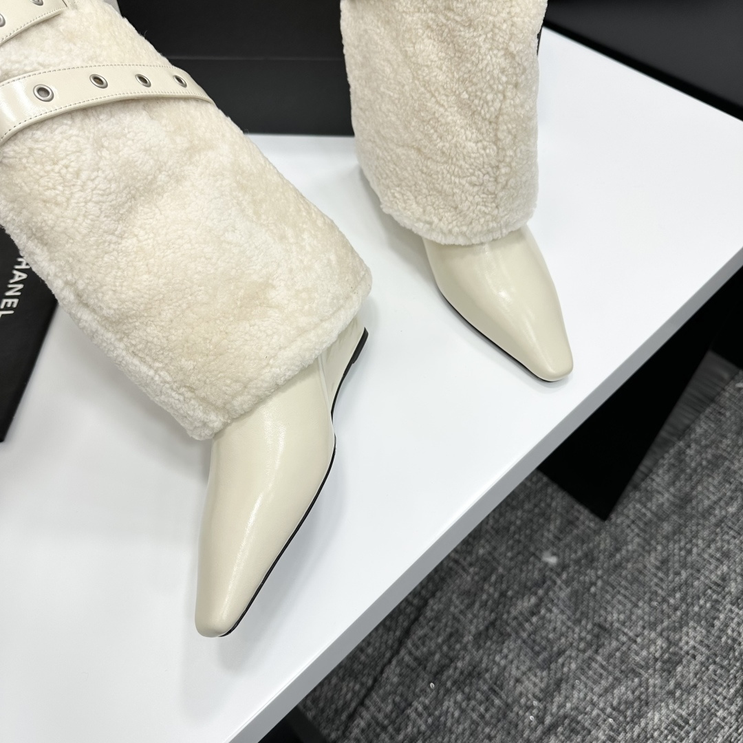 Cream-colored pointed toe wedge boots featuring a plush faux fur shaft and decorative silver buckle straps on a black display box. - Hình 8