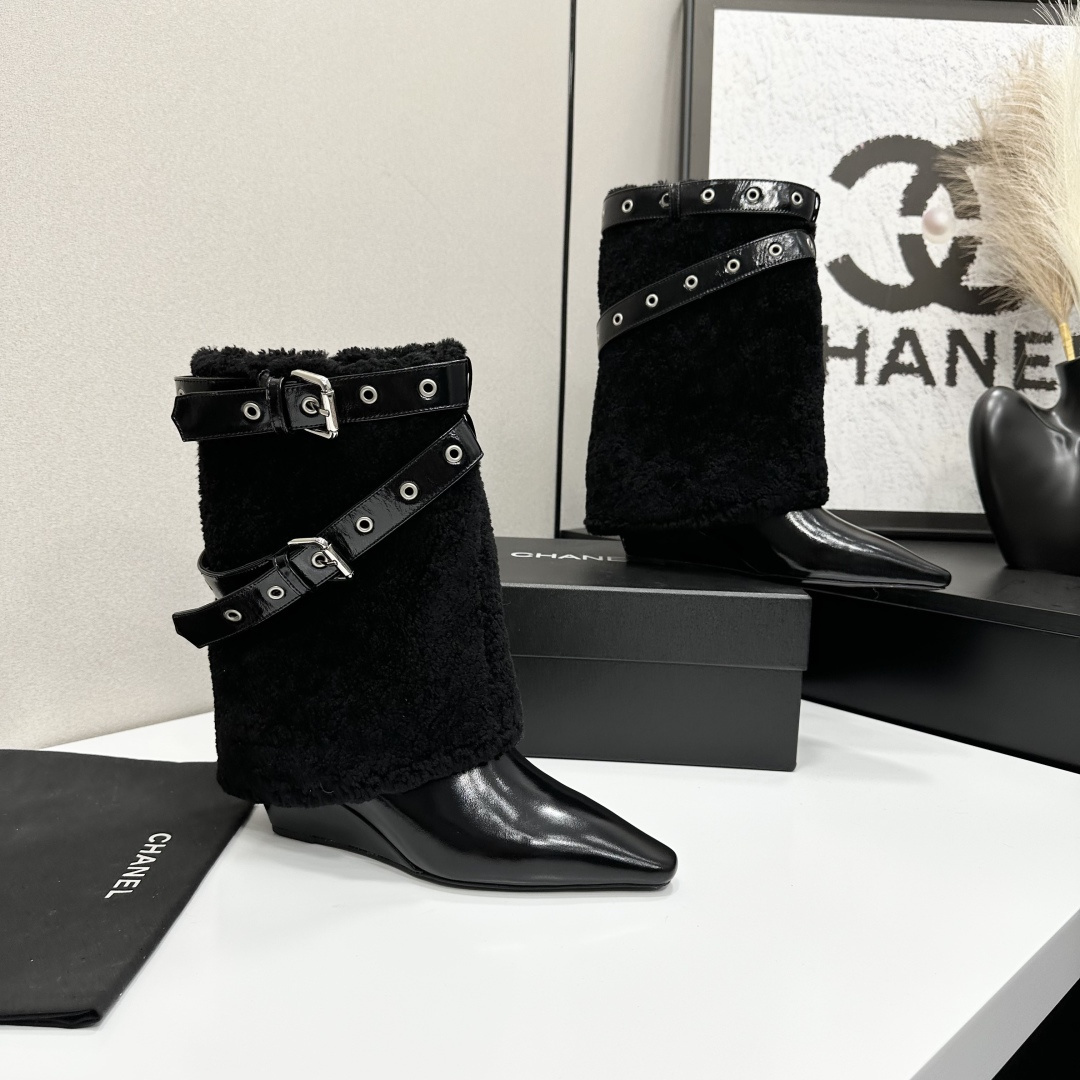 Luxury black shearling ankle boots with silver buckle straps and pointed toes sitting on a black designer box. - Hình 9