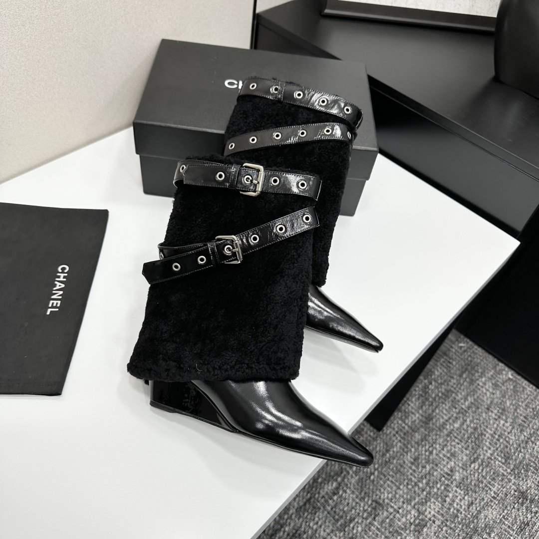 Luxury black shearling ankle boots with silver buckle straps and pointed toes sitting on a black designer box. - Hình 7