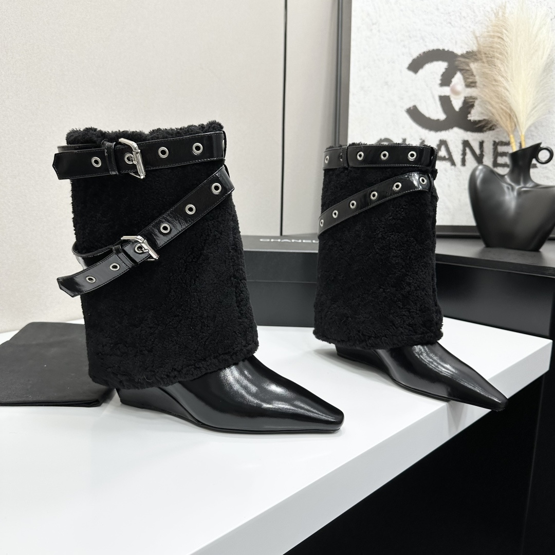 Luxury black shearling ankle boots with silver buckle straps and pointed toes sitting on a black designer box. - Hình 6
