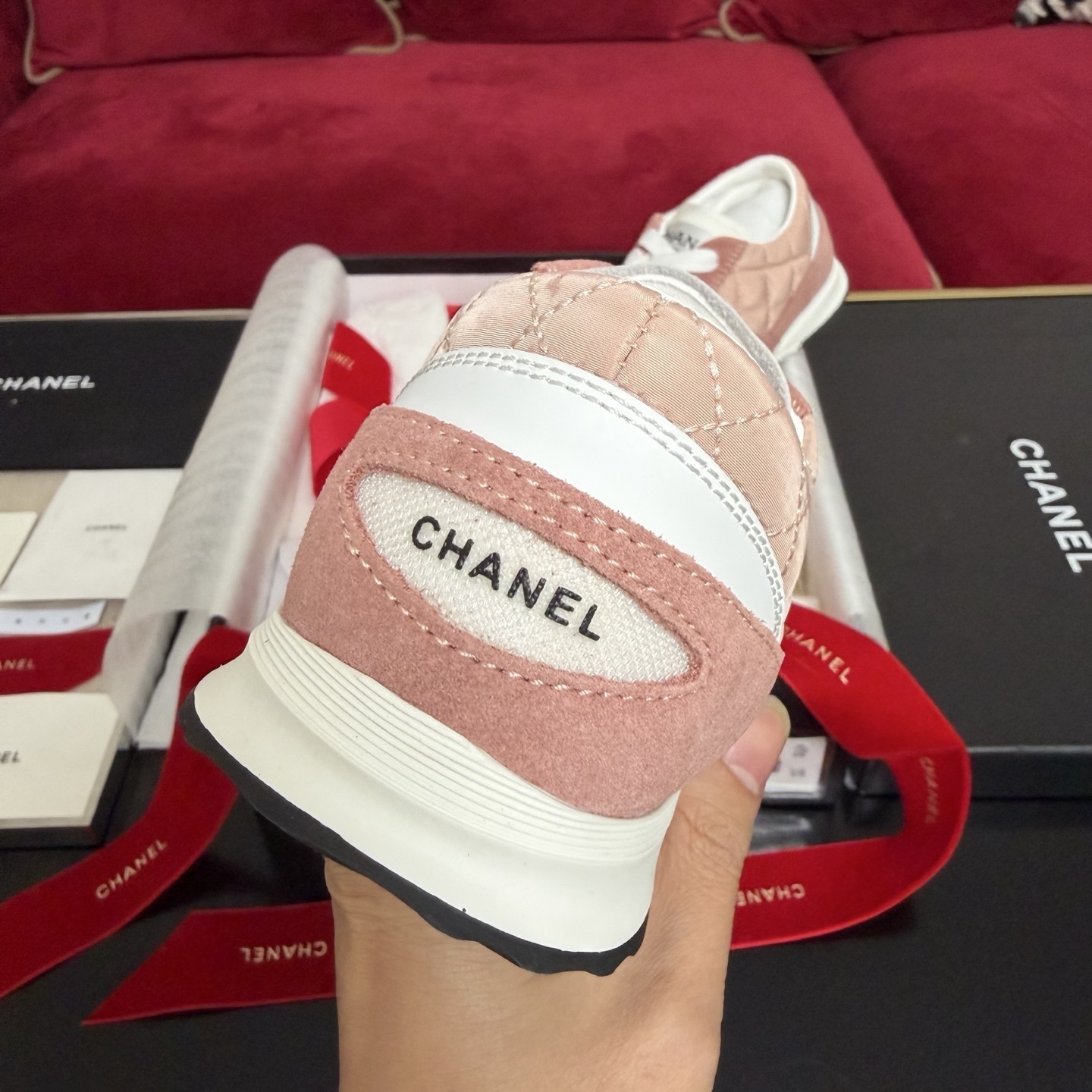 Authentic pink quilted Chanel sneakers with white laces and interlocking CC logo in original packaging with red ribbon. - Hình 8