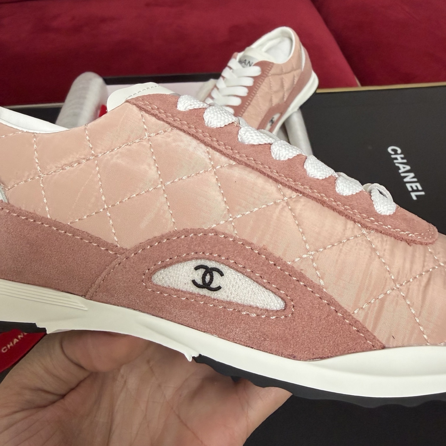 Authentic pink quilted Chanel sneakers with white laces and interlocking CC logo in original packaging with red ribbon. - Hình 7