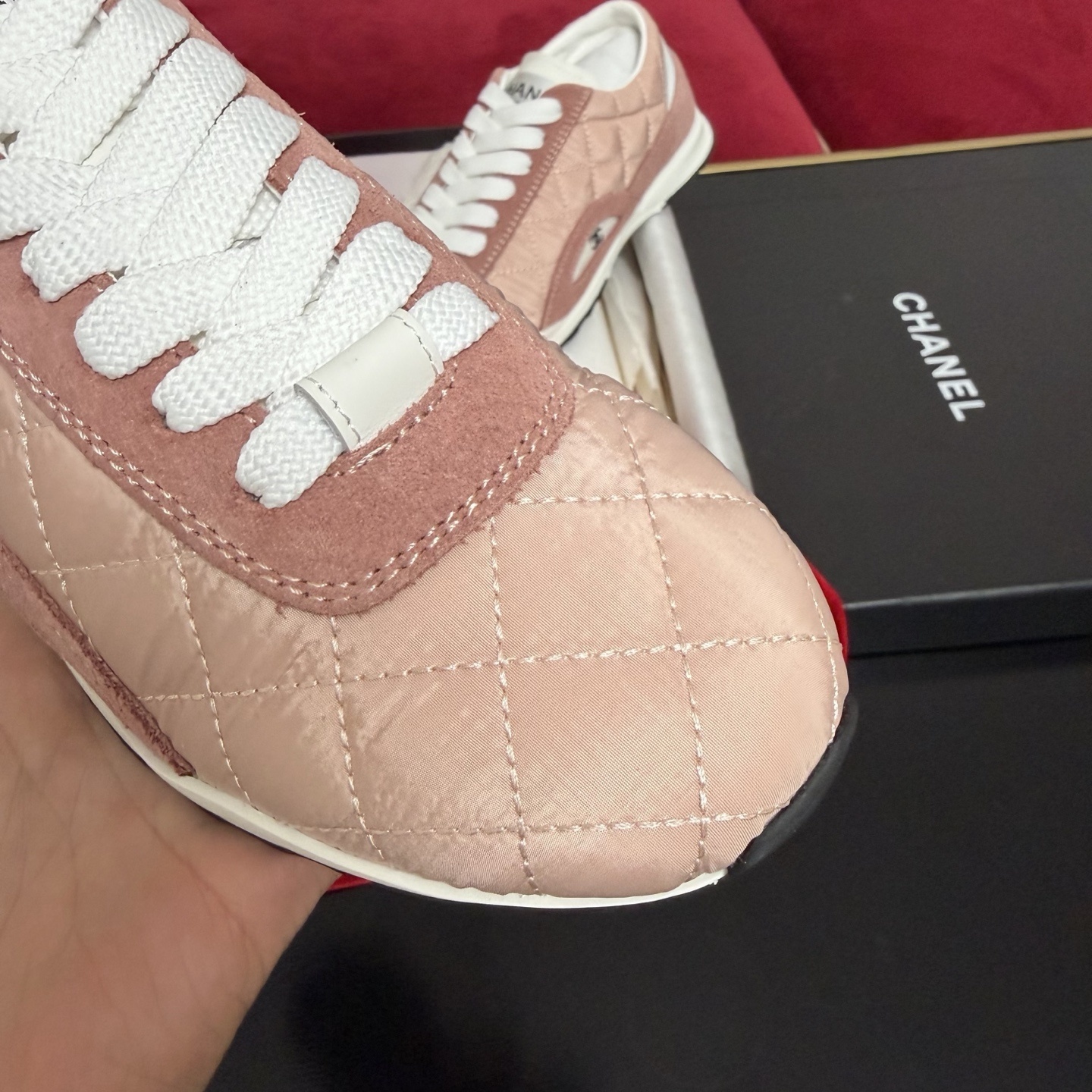 Authentic pink quilted Chanel sneakers with white laces and interlocking CC logo in original packaging with red ribbon. - Hình 6