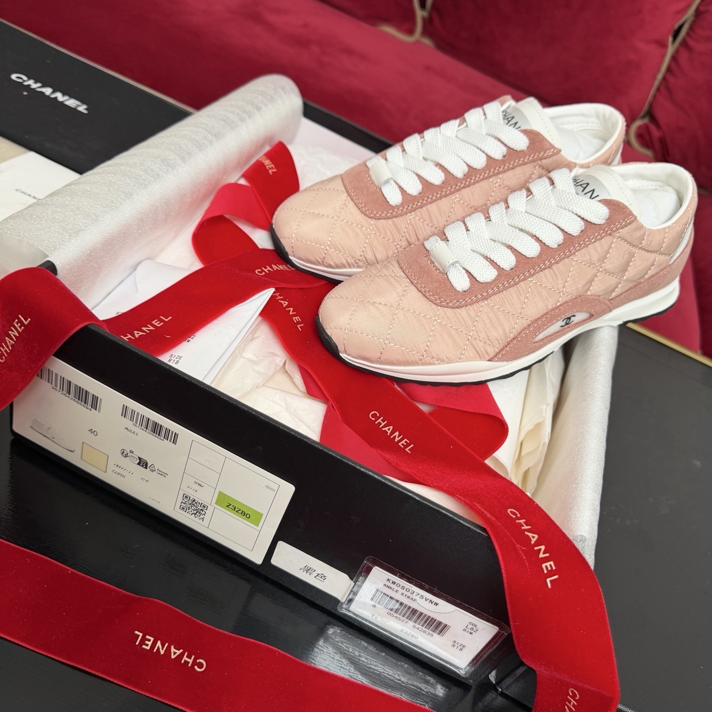 Authentic pink quilted Chanel sneakers with white laces and interlocking CC logo in original packaging with red ribbon. - Hình 2